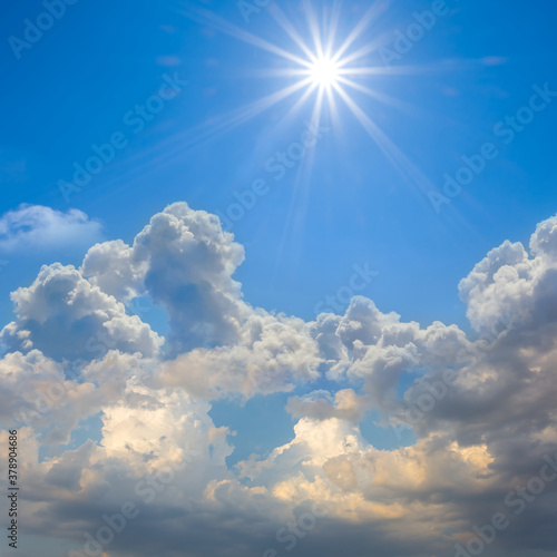 sparkle sun over a dense cumulus clouds  blue sky natural background