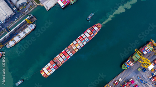 Container ship carrying container boxs in import and export business commercial logistic and freight shipping transportation by container ship, Container loading cargo ship, Aerial top view.