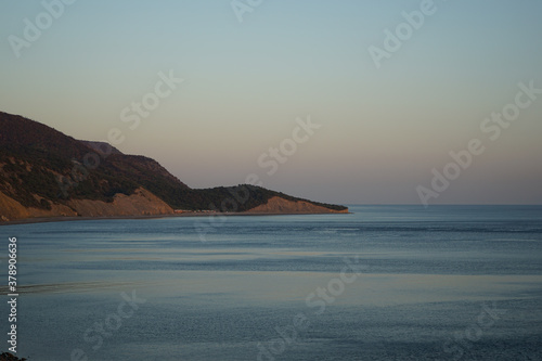 beautiful view of the sea and rocky coast in the evening at sunset