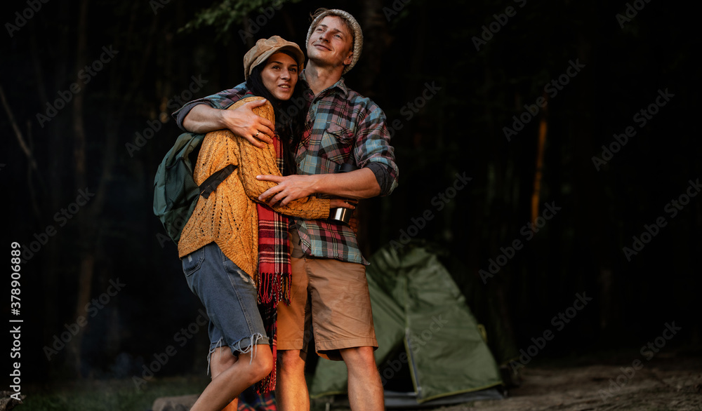Portrait of happy young hipster couple in love. Camping couple. Forest background. Love. 