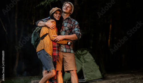 Portrait of happy young hipster couple in love. Camping couple. Forest background. Love. 