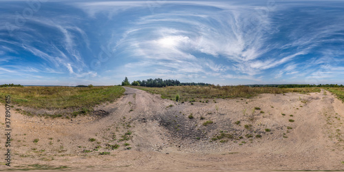 Full spherical seamless hdri panorama 360 degrees angle view on no traffic sand gravel road among fields with clear sky with beautiful clouds in equirectangular projection  VR AR content