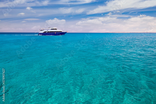 Luxury cruise yacht in clear water near a coral reef. Red Sea, Egypt © Anton Petrus