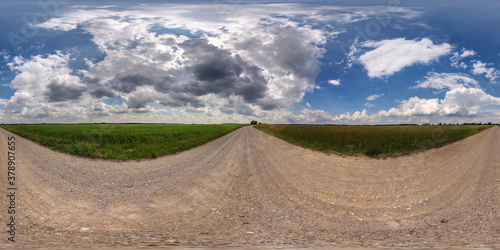 Full spherical seamless hdri panorama 360 degrees angle view on no traffic sand gravel road among fields with clear sky with beautiful clouds in equirectangular projection, VR AR content