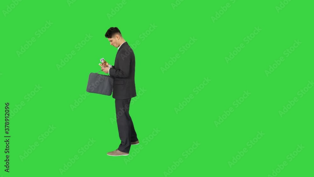Young business man walking counting euro bills on a Green Screen, Chroma Key. Young business man walking counting euro bills on a Green Screen, Chroma Key.