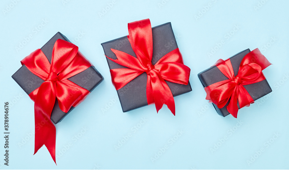 Black friday sale flat lay with gift box and ribbon, copy space, christmas and holidays concept on blue background Black friday sale flat lay with gift box and ribbon, copy space, christmas and holidays concept on blue background
