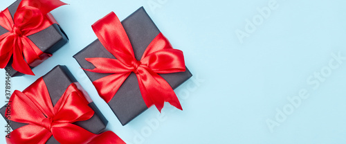 Black friday sale flat lay with gift box and ribbon  copy space  christmas and holidays concept on blue background