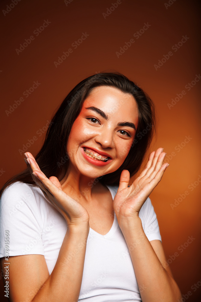 pretty girl happy posing: brunette on brown background, lifestyle people concept pretty girl happy posing: brunette on brown background, lifestyle people concept