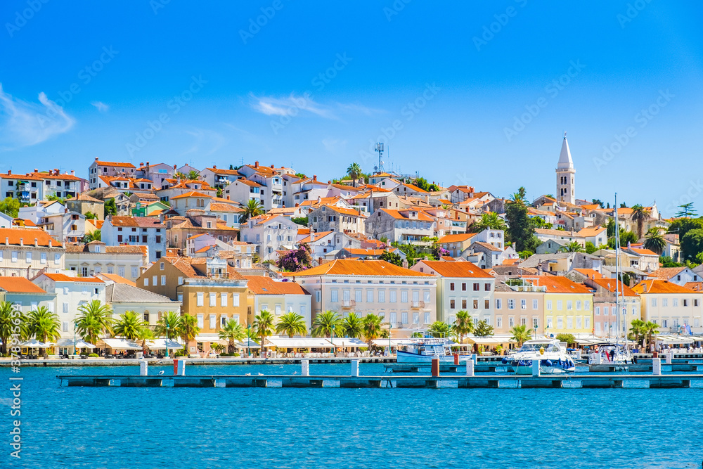 Town of Mali Losinj on the island of Losinj, Croatia, seafront and city skyline with old cathedral tower