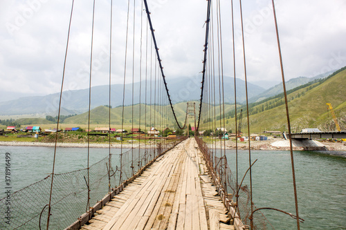 Suspension bridge across river in Altai