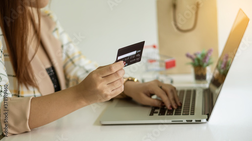 Online holiday shopping ideas with pay credit card David via laptop.