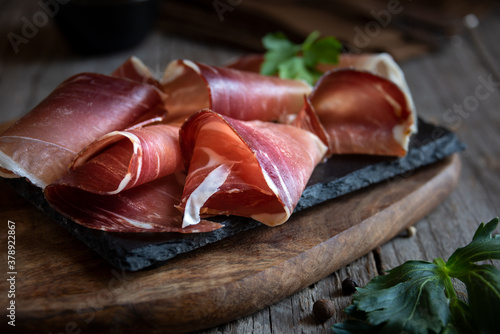 Italian prosciutto or jamon with rosemary, raw ham