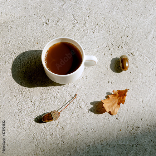 Cup of acorn coffee on a gray background. Substitute to atraditional coffee, a healthy homemade eco-friendly hot drink with a coffee flavor. Health and no caffeine concept. Flat lay photo