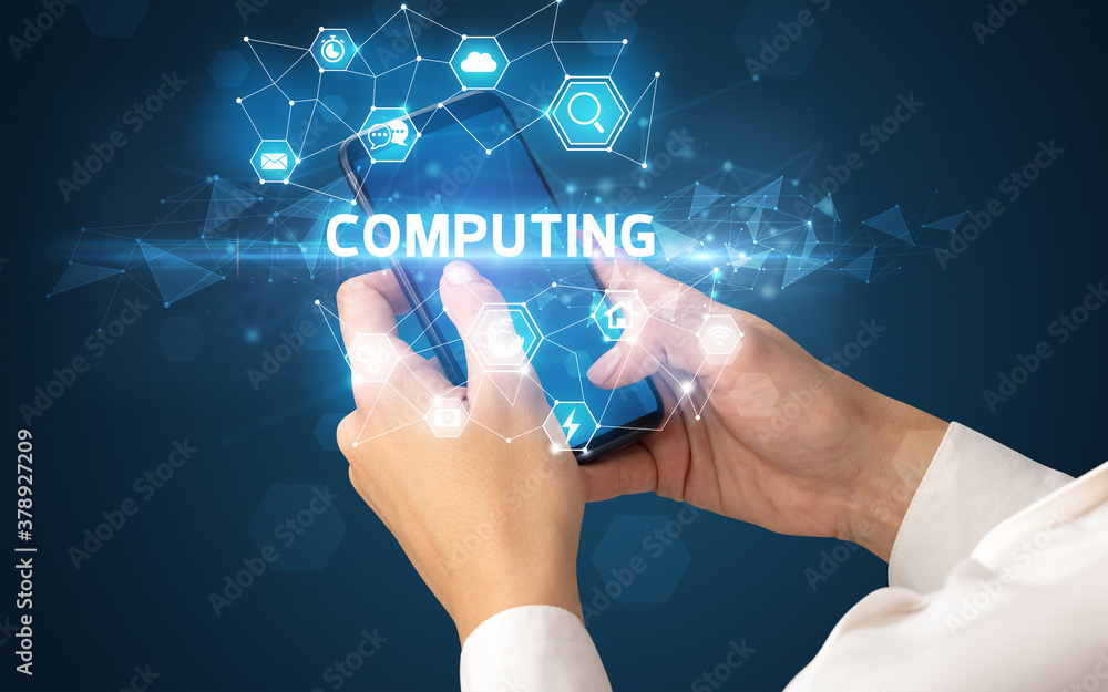 Female hand holding smartphone with COMPUTING inscription, modern technology concept Female hand holding smartphone with COMPUTING inscription, modern technology concept