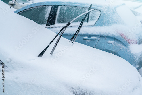 Parked car covered with snow