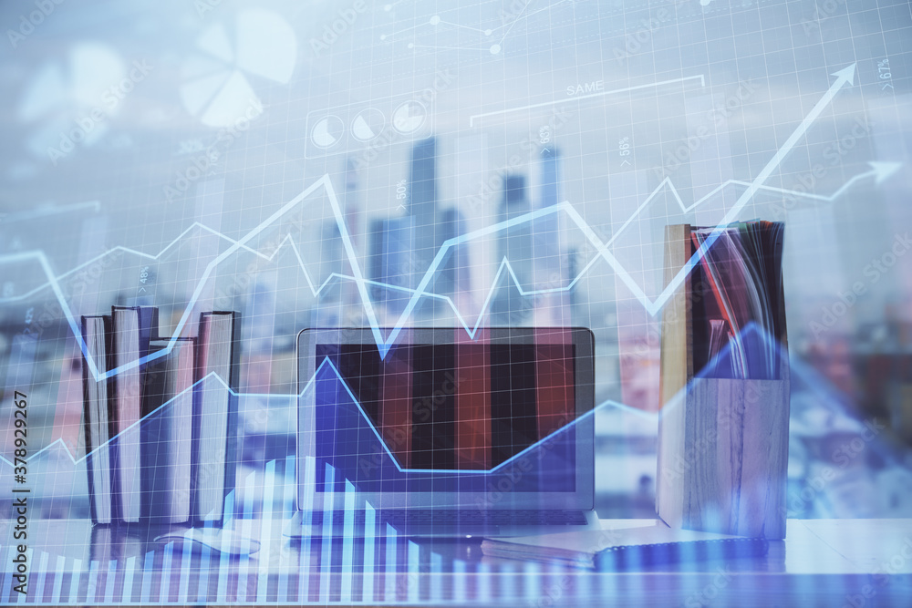 Stock market chart hologram drawn on personal computer background. Multi exposure. Concept of investment. Stock market chart hologram drawn on personal computer background. Multi exposure. Concept of investment.