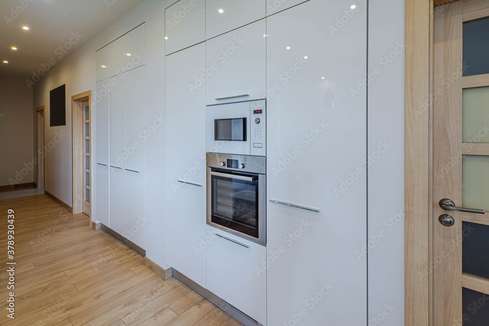 Wall with built-in kitchen set with oven and microwave. Contemporary interior. Luxury flat. Wall with built-in kitchen set with oven and microwave. Contemporary interior. Luxury flat.