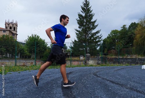 young man running in a park © Egoitzainhoa