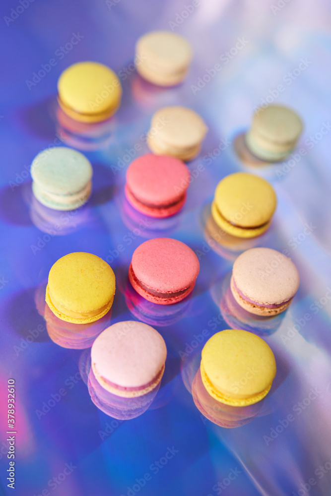 French cake macaron. Set of cute sweets on colorful rainbow background. almond cookies, pastel colors, top view French cake macaron. Set of cute sweets on colorful rainbow background. almond cookies, pastel colors, top view