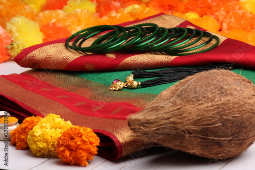 oti bharne - Indian ritual of offering a sari and a blouse piece along with coconut, haldi kumkum, bangles, mangalsutra and rice. At the time of navratri to goddes or married woman. photo