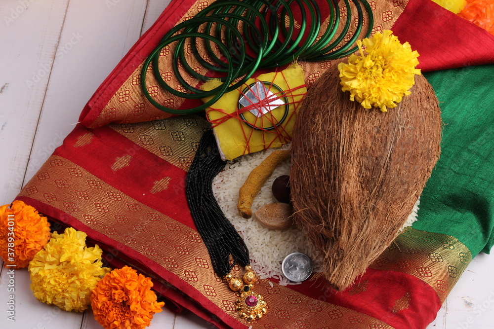 oti bharne - Indian ritual of offering a sari and a blouse piece along with coconut, haldi kumkum, bangles, mangalsutra and rice. At the time of navratri to goddes or married woman.