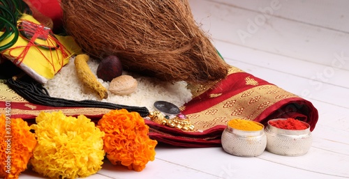 oti bharne - Indian ritual of offering a sari and a blouse piece along with coconut, haldi kumkum, bangles, mangalsutra and rice. At the time of navratri to goddes or married woman. photo