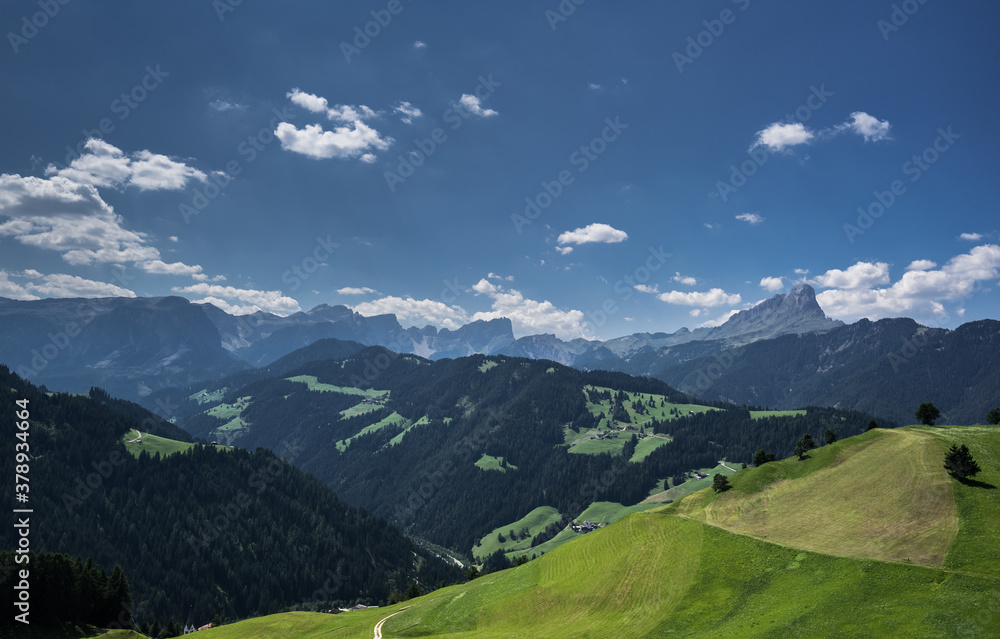 Fototapeta premium Alpine meadows and Sass de Putia/Peitlerkofel solitary mountain in the background, as seen from the hiking trail around La Val village, South Tirol, Italy.
