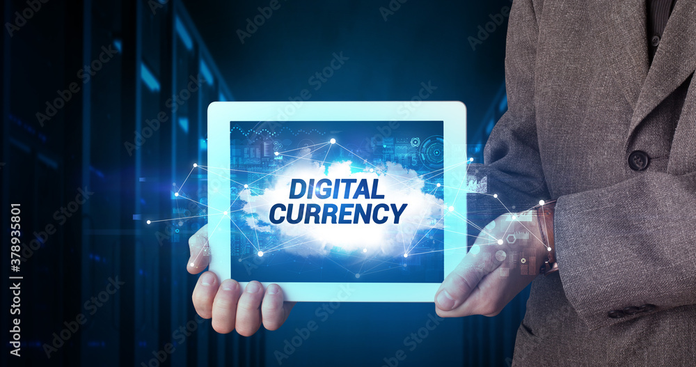 Young business person working on tablet and shows the inscription: DIGITAL CURRENCY Young business person working on tablet and shows the inscription: DIGITAL CURRENCY