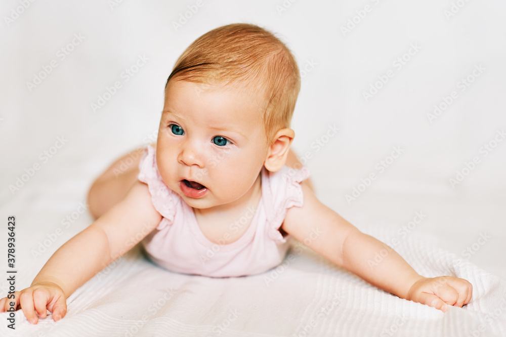 Portrait of adorable baby lying on belly, white background Portrait of adorable baby lying on belly, white background
