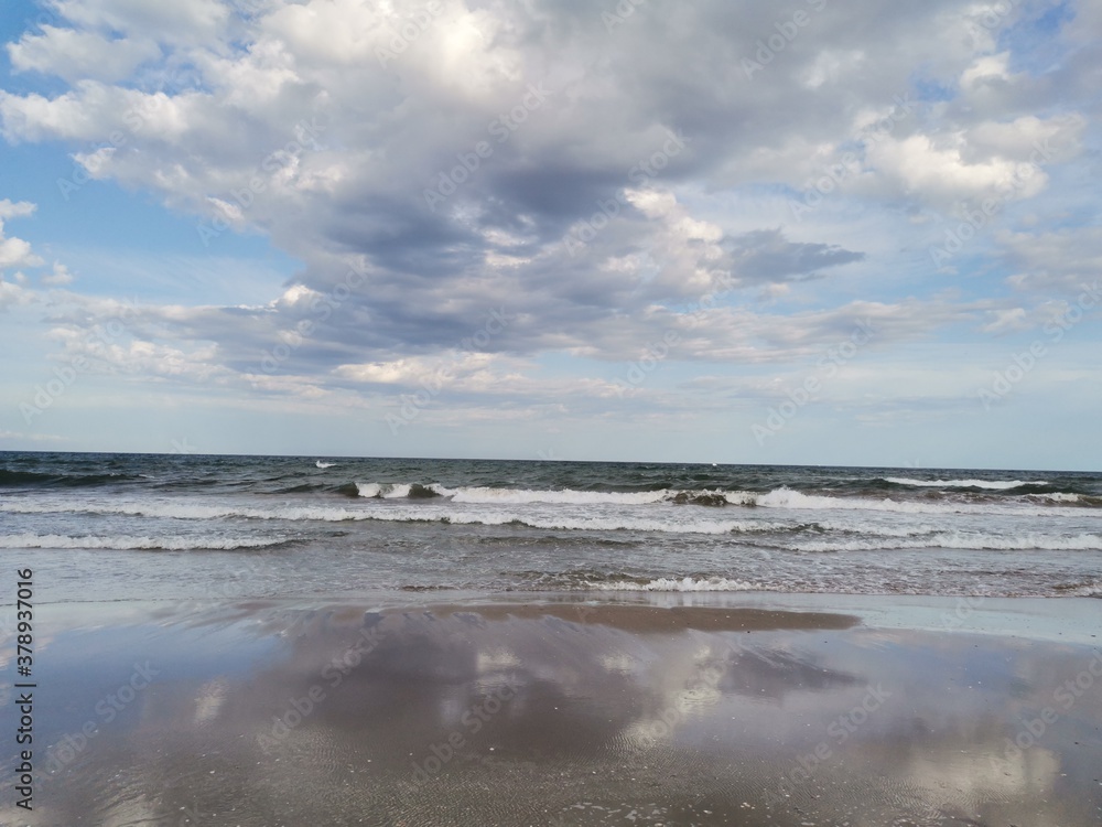 Cloud reflection on the beach