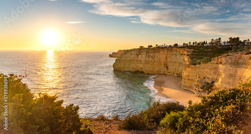 Natural caves and beach, Algarve Portugal. Rock cliff arches of Seven Hanging Valleys and turquoise sea water on coast of Portugal in Algarve region