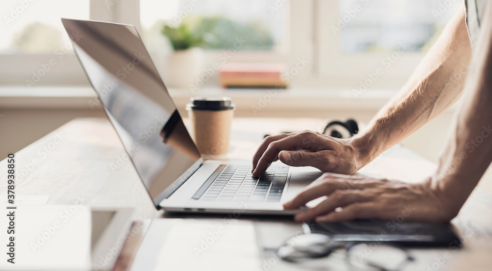 Man hands typing on computer keyboard closeup, businessman or student using laptop at home, panoramic banner, online learning, internet marketing, working from home, office workplace freelance concept Man hands typing on computer keyboard closeup, businessman or student using laptop at home, panoramic banner, online learning, internet marketing, working from home, office workplace freelance concept