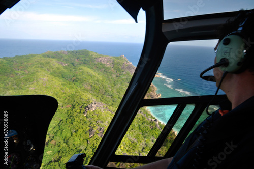 La Digue Island / Seychelles - August 3 2010: tropical island view through the helicopter window with the pilot