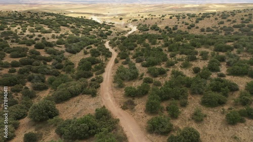 Aerial shot of SUV racing car in the desert of international rally event photo