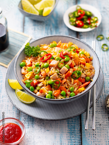 Wallpaper Mural Asian fried rice with ham and vegetables. Blue wooden background. Close up. Torontodigital.ca