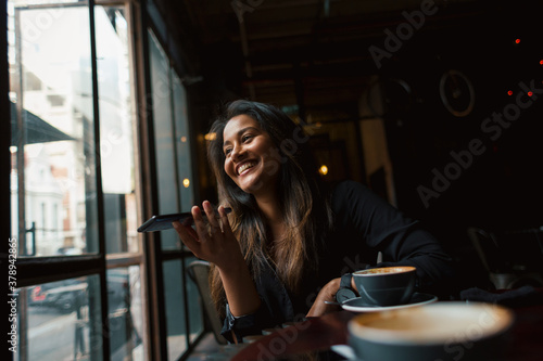 Young woman in coffee shop smiling
