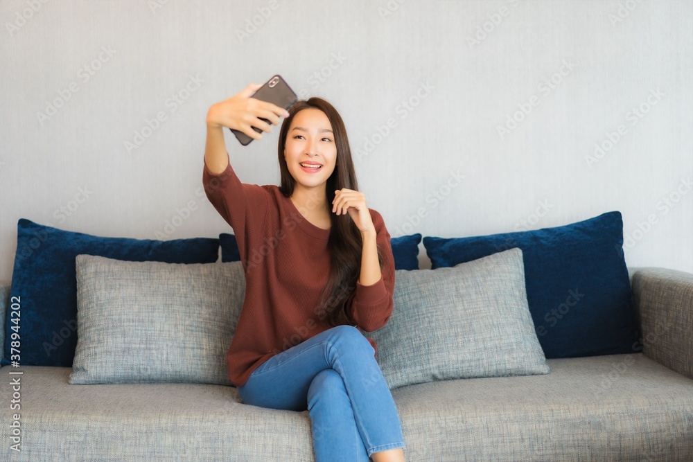 Portrait beautiful young asian woman use smart phone on sofa Portrait beautiful young asian woman use smart phone on sofa
