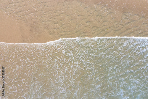 The Atlantic Ocean washes onto a scenic, sandy beach on Cape Cod, Massachusetts. This scenic peninsula is a popular summer vacation destination in New England. photo