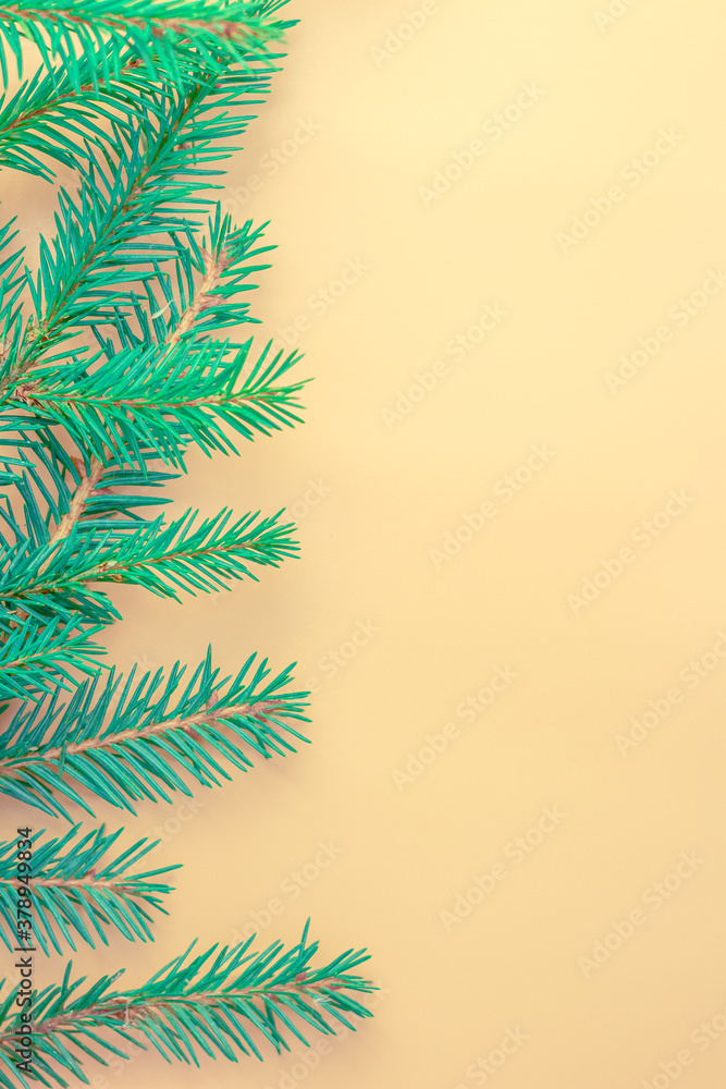 Composition with a decorated Christmas tree on a beige background with space for text. Christmas layout or greeting card. The view from the top.
