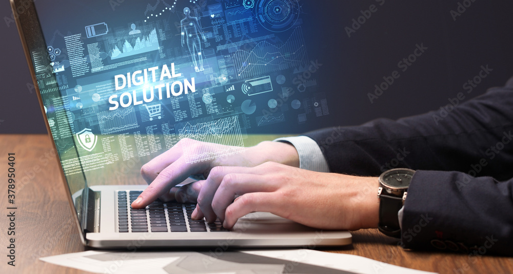 Businessman working on laptop with DIGITAL SOLUTION inscription, cyber technology concept Businessman working on laptop with DIGITAL SOLUTION inscription, cyber technology concept