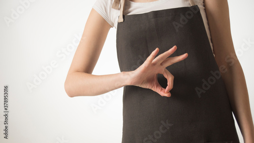 woman in kitchen apron shows something