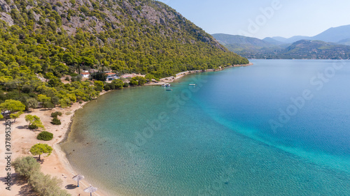 Aerial view on turqouise blue water and sandy beach of Limni Vouliagmeni or Ireon Lake  Peloponnese  Greece  