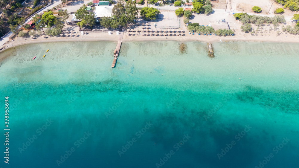 Aerial view on turqouise blue water and sandy beach of Limni Vouliagmeni or Ireon Lake, Peloponnese, Greece  