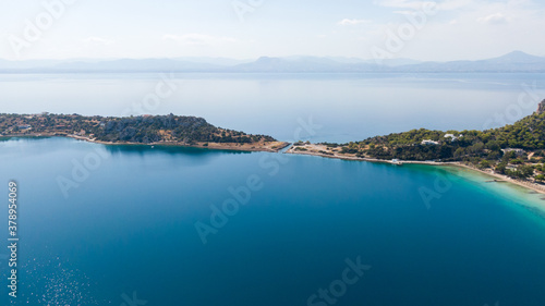 Aerial view on turqouise blue water and sandy beach of Limni Vouliagmeni or Ireon Lake, Peloponnese, Greece 