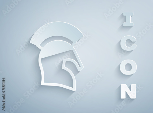 Paper cut Greek helmet icon isolated on grey background. Antiques helmet for head protection soldiers with a crest of feathers or horsehair. Paper art style. Vector.