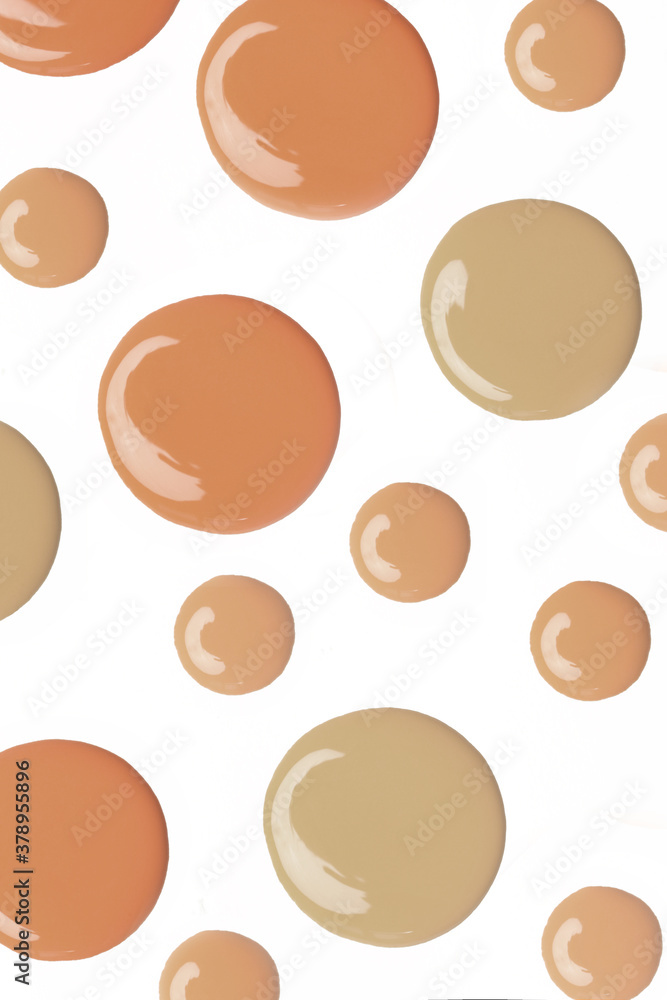 Liquid foundation drops isolated on white background. Makeup color swatches.