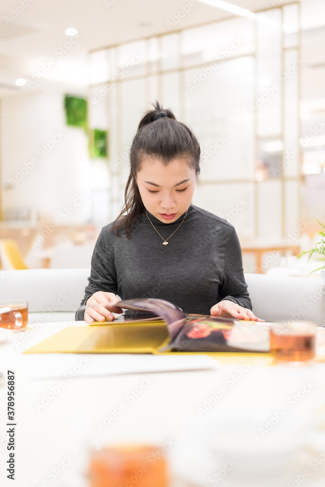Young women ordering food in restaurant Young women ordering food in restaurant