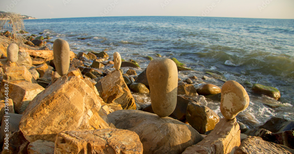 Balanced stones on the seashore summertime and sea background Balanced stones on the seashore summertime and sea background