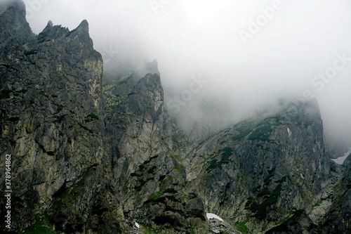  The peaks of the High Tatras with white clouds. Mountains in the clouds. High Tatras Mountains in Slovakia