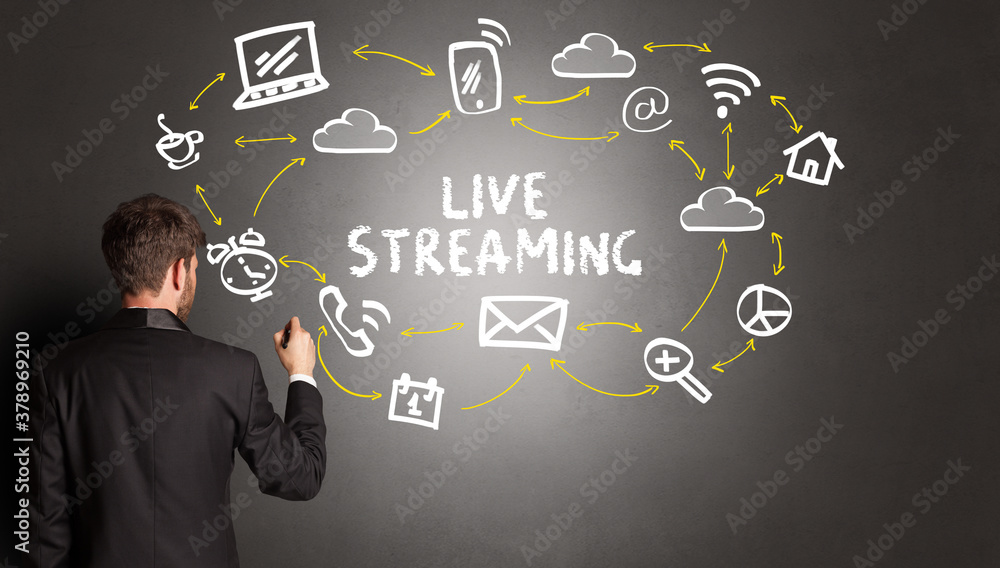 businessman drawing social media icons with LIVE STREAMING inscription, new media concept businessman drawing social media icons with LIVE STREAMING inscription, new media concept